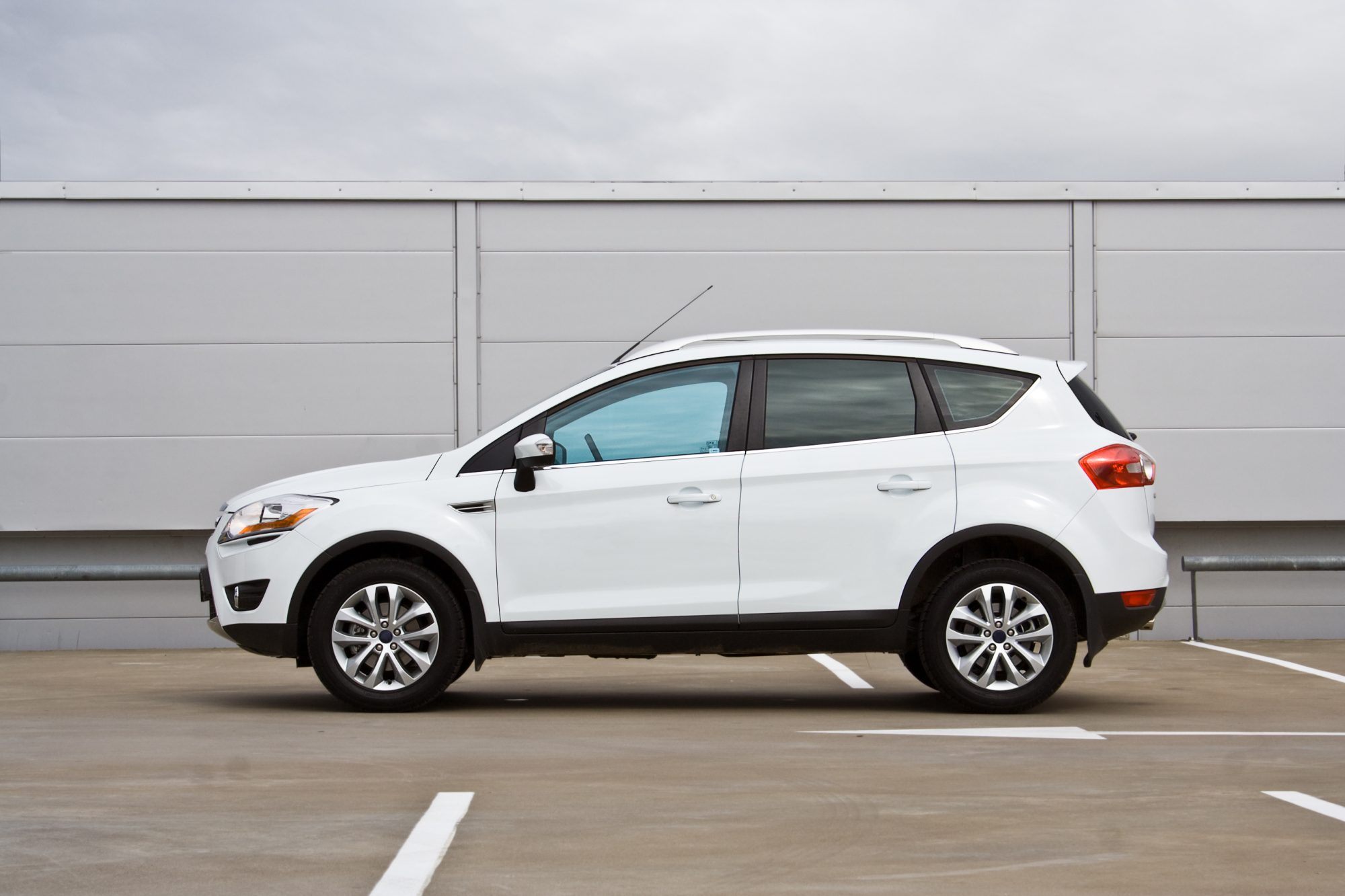 Side view of a compact SUV. Parking lot.